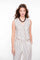 Geisha Fashion: Woman wearing striped outfit, standing plain background.
